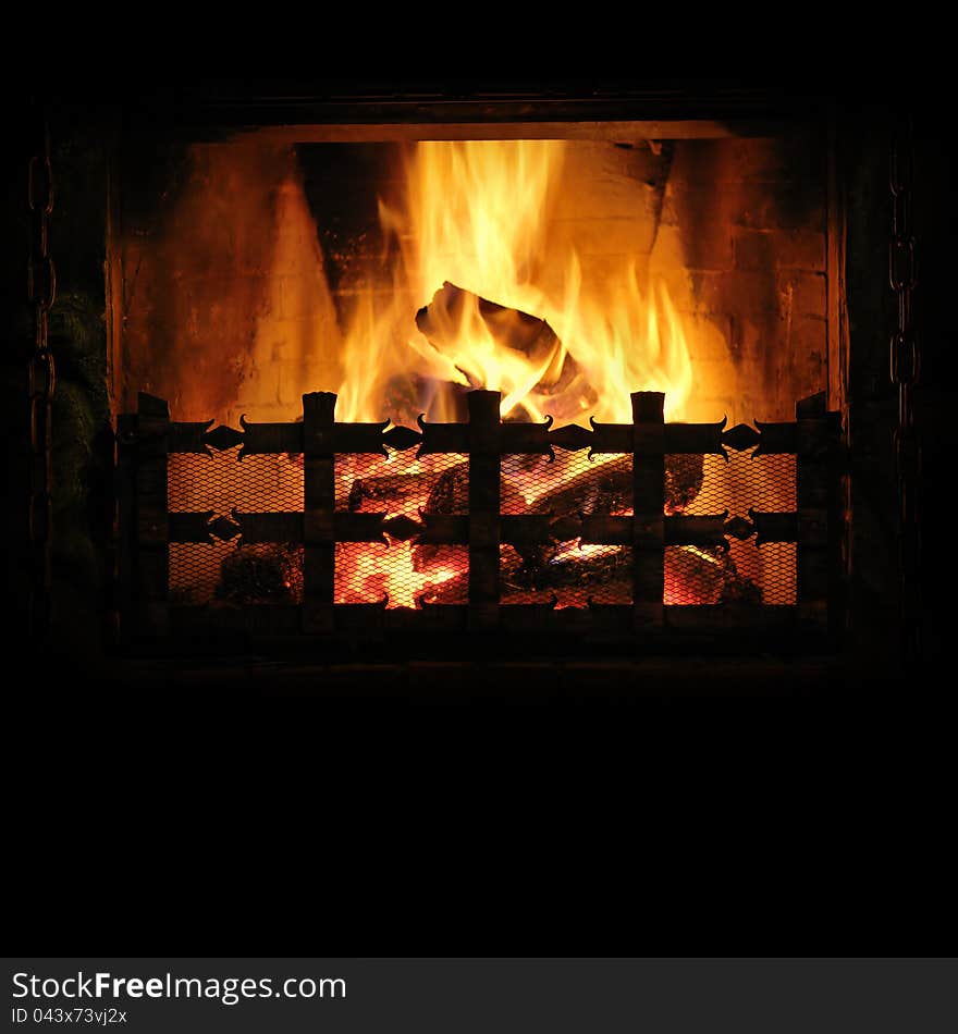 Fireplace with a blazing fire. Background for design. Fireplace with a blazing fire. Background for design