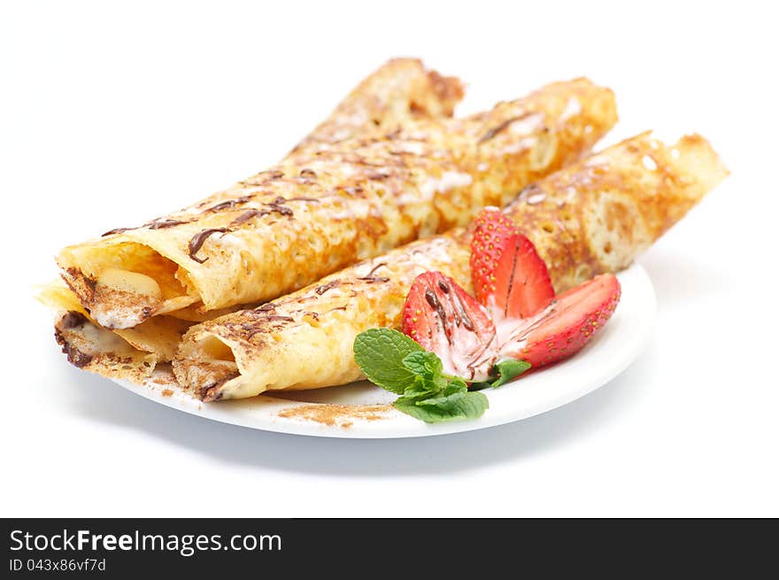 Pancakes with strawberry and glaze and leaflets of mint