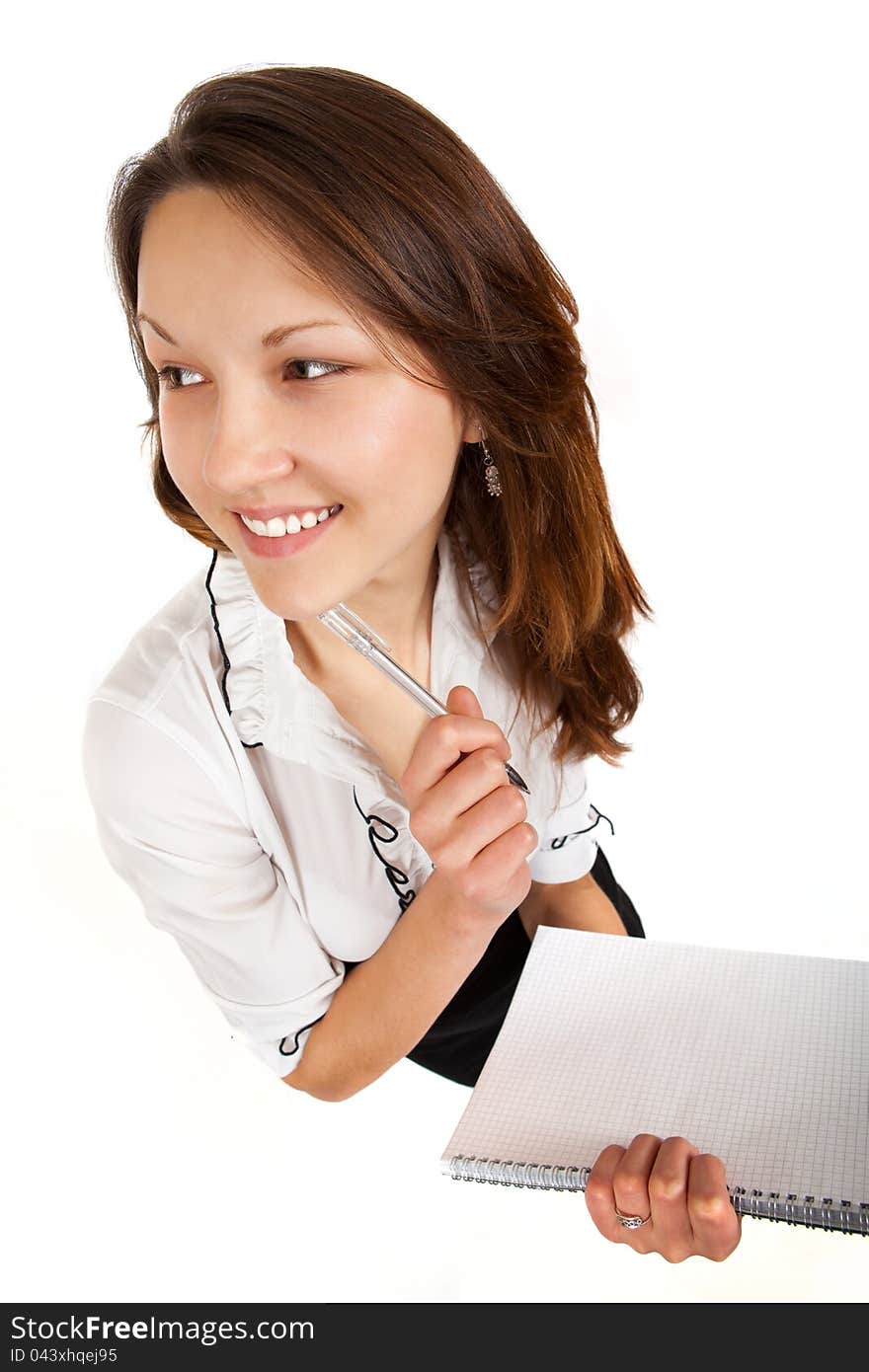 Girl with a notebook and pen on a white background. Girl with a notebook and pen on a white background