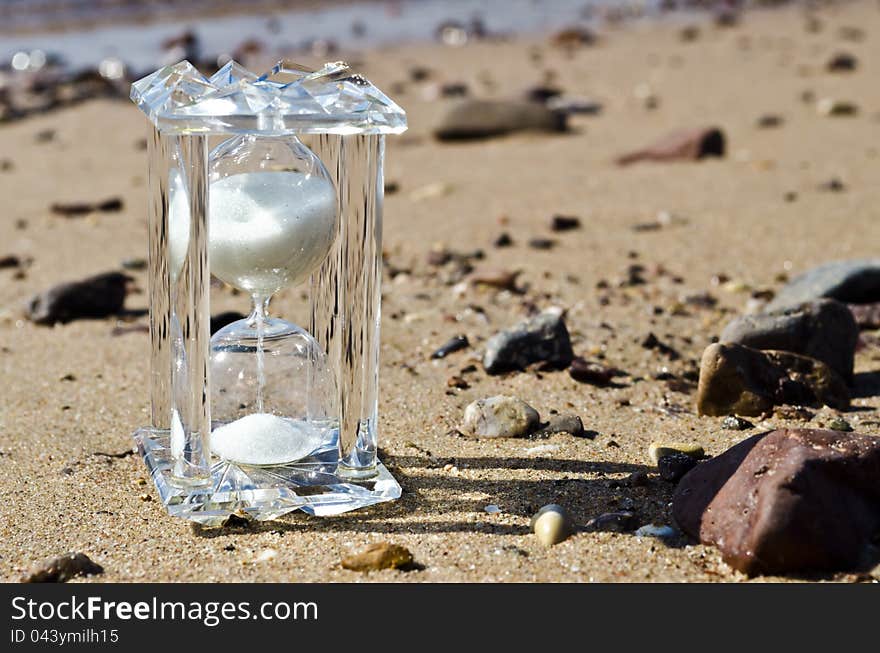 Crystal hourglass on marine beach