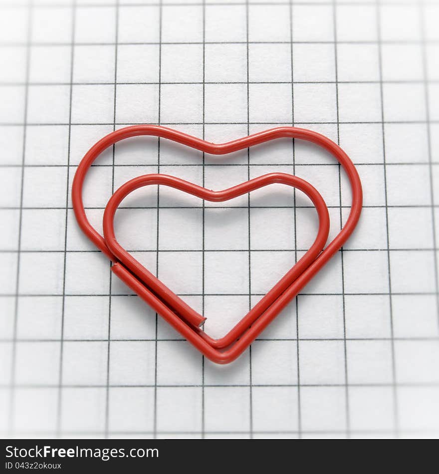 Closeup of heart shaped red paper clip. Closeup of heart shaped red paper clip