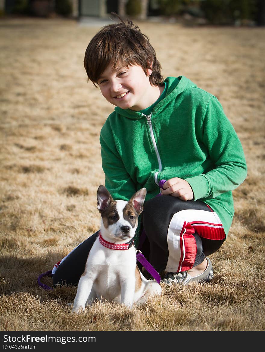 A boy poses with his hybrid canine mixed breed including cattle dog and boxer. A boy poses with his hybrid canine mixed breed including cattle dog and boxer.