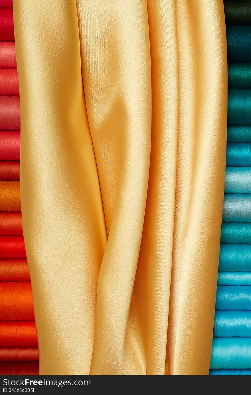 Colored bobbins and golden silk