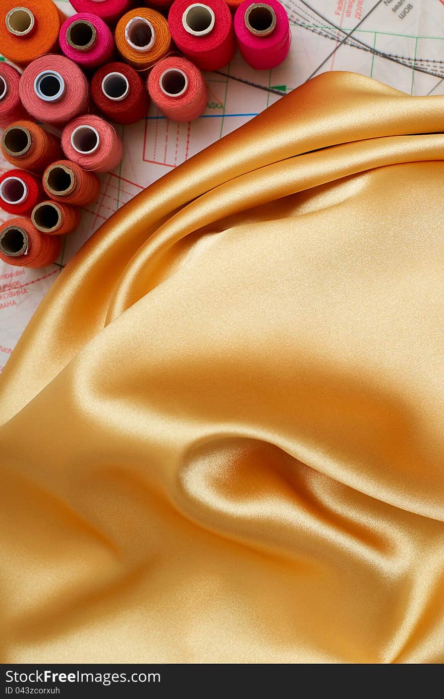 Colored bobbins and golden silk