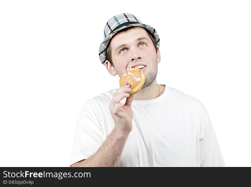 Man in a hat with a donut in his hand. Man in a hat with a donut in his hand