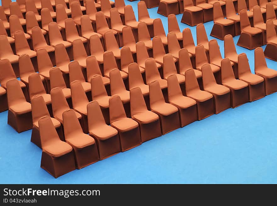 Brown seats on blue carpet in the convention hall