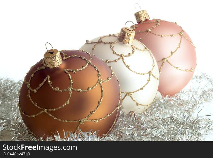 Triad round Christmas decorations on white ground