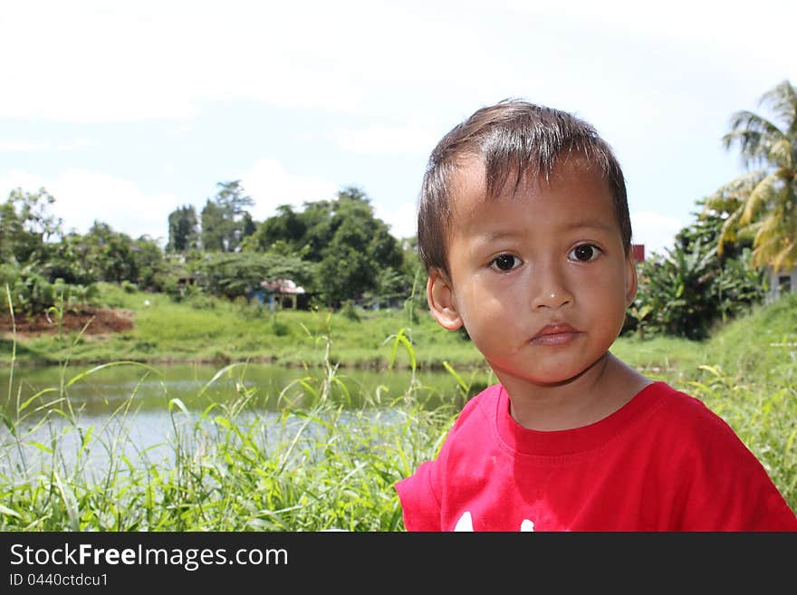 A child were standing at the lake.