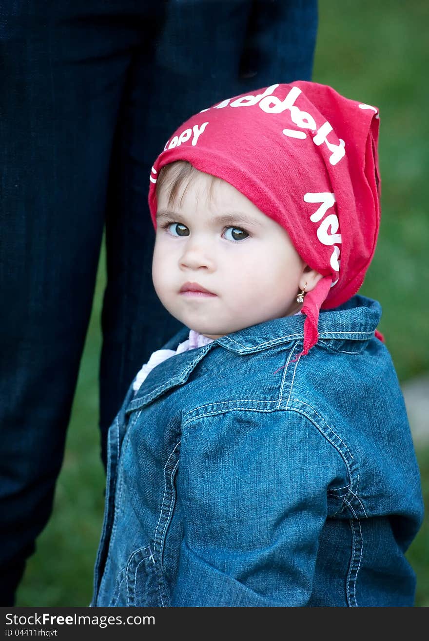 Little girl wearing jeans and red scarf