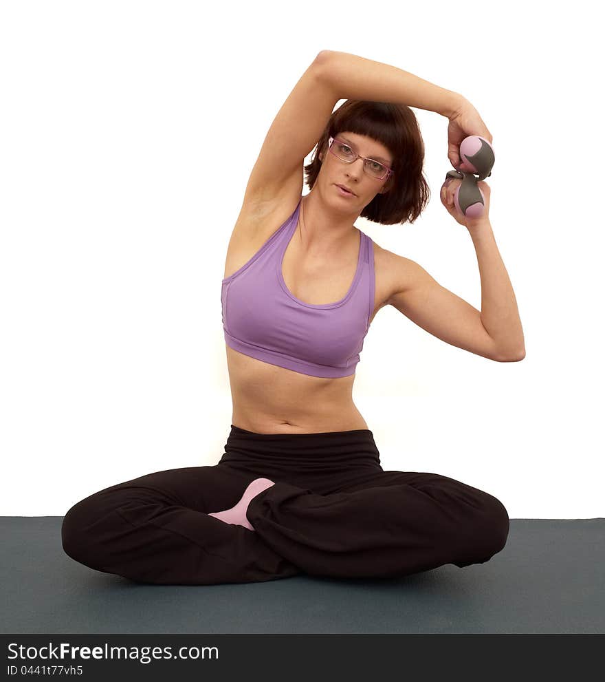 Beautiful young woman doing exercises. White background.