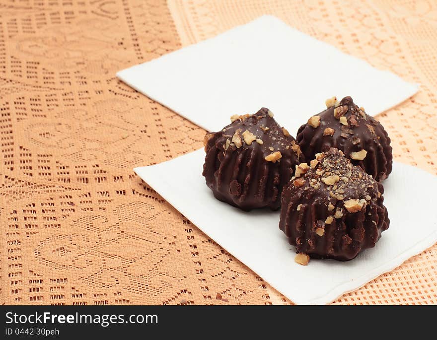 Chocolate truffle cakes with peanuts on napkins