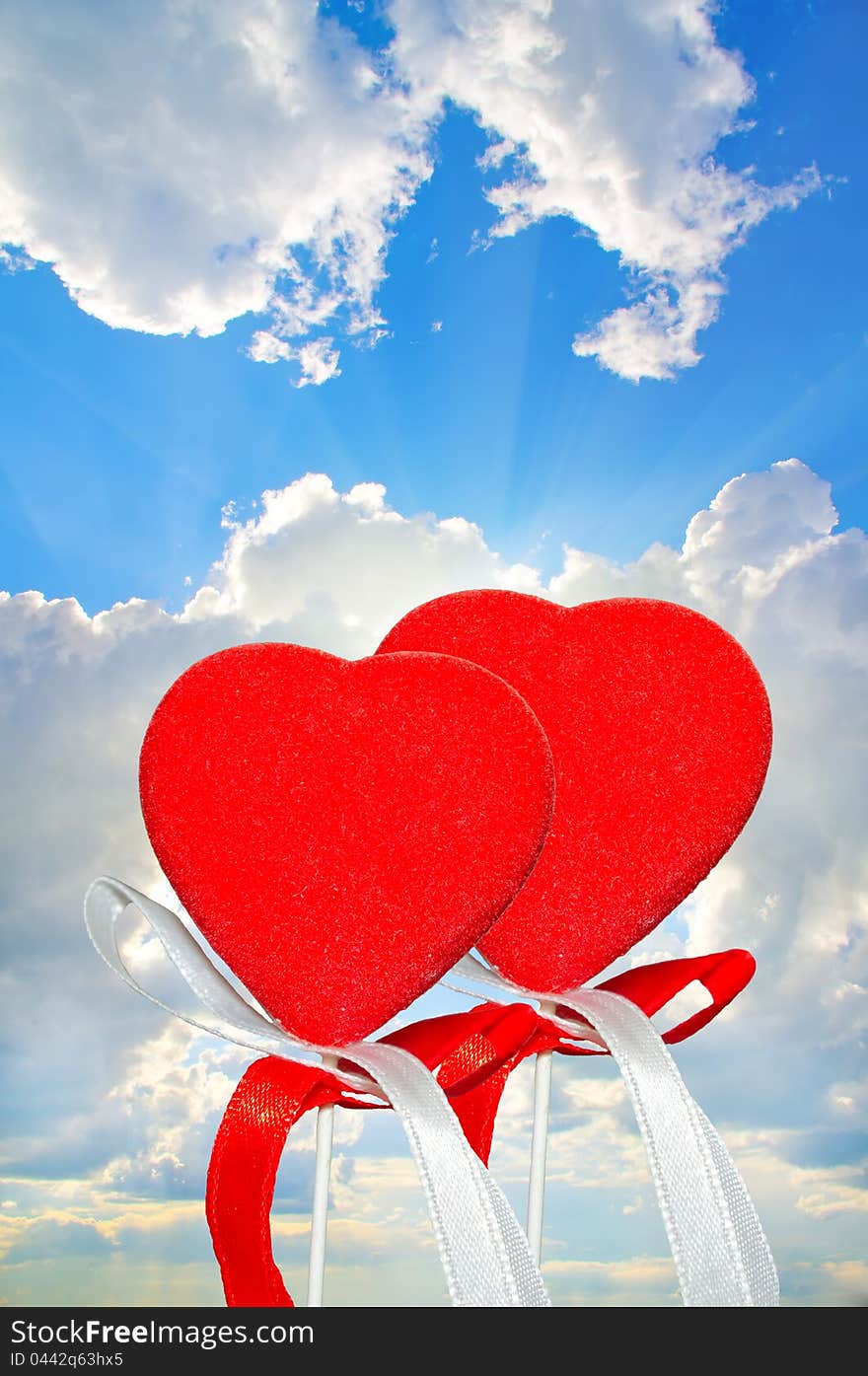 Two hearts on the sky background