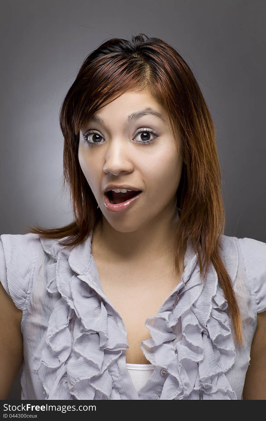 A latino woman looks at the camera in astonishment. A latino woman looks at the camera in astonishment