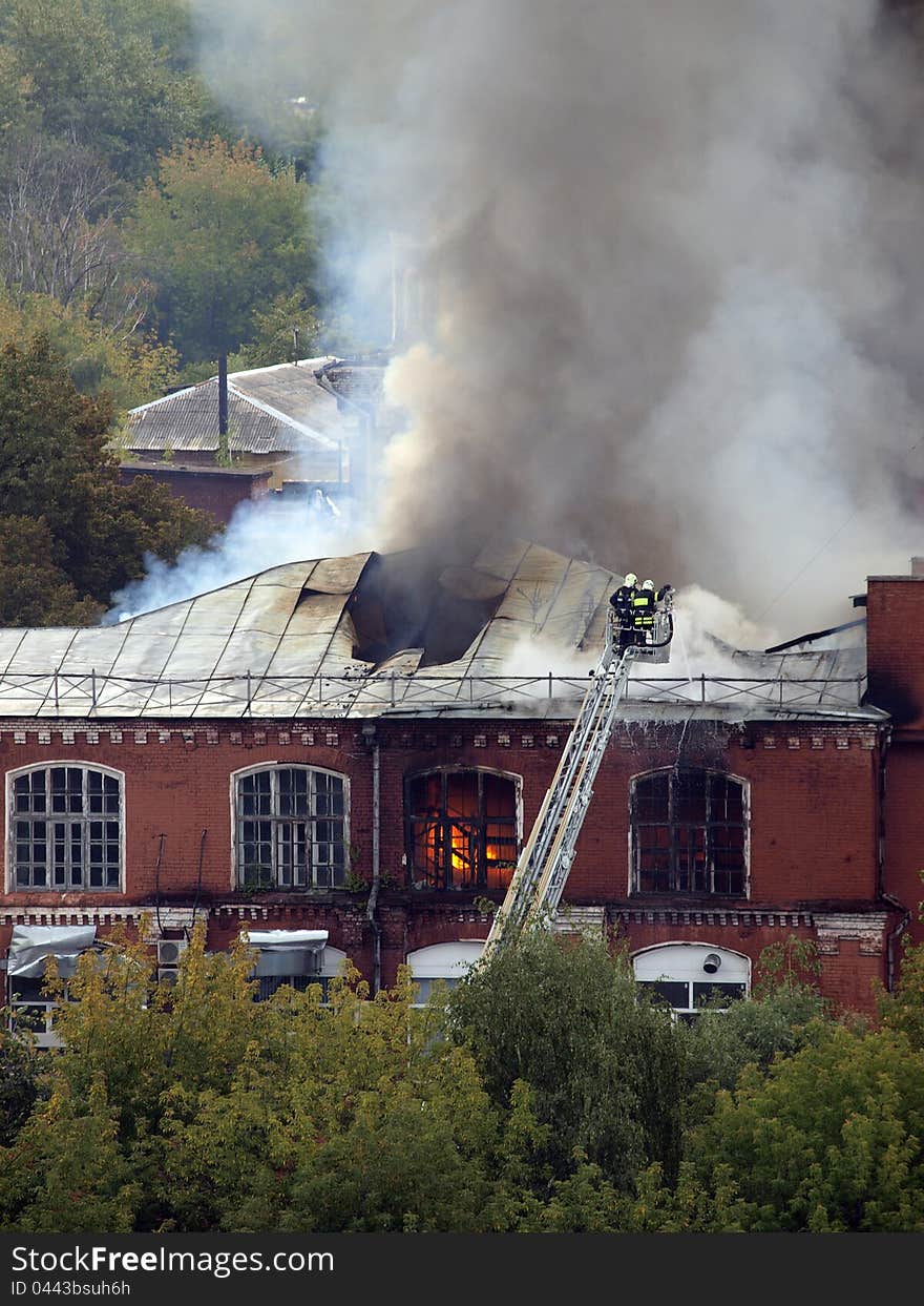 Firefighters extinguish a burning building. Firefighters extinguish a burning building