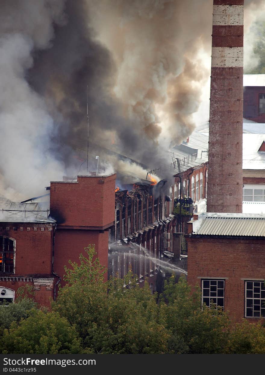 Firefighters extinguish a burning building. Firefighters extinguish a burning building