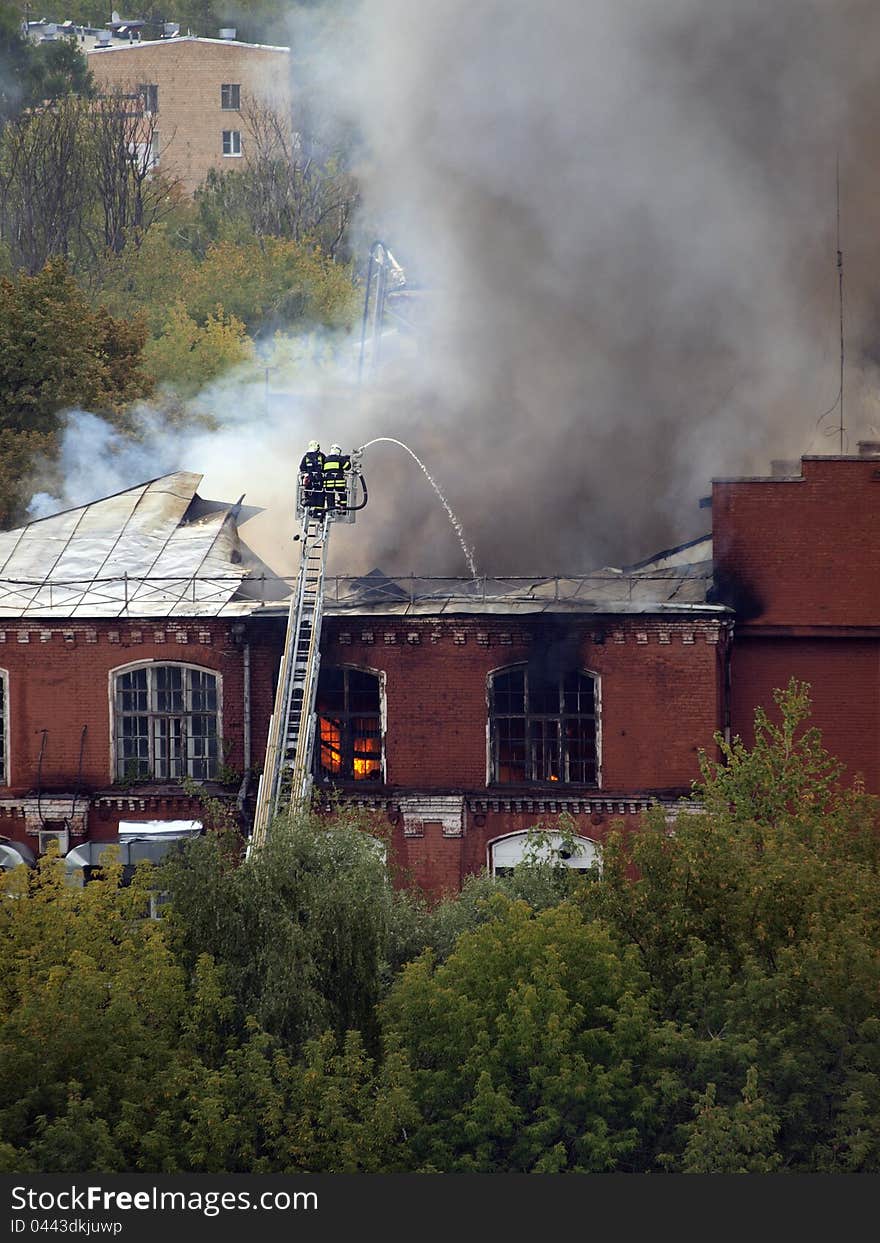 Firefighters extinguish a burning building. Firefighters extinguish a burning building