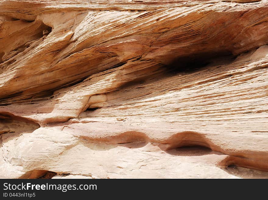 A Span of rock wall with lines and crevasses. A Span of rock wall with lines and crevasses