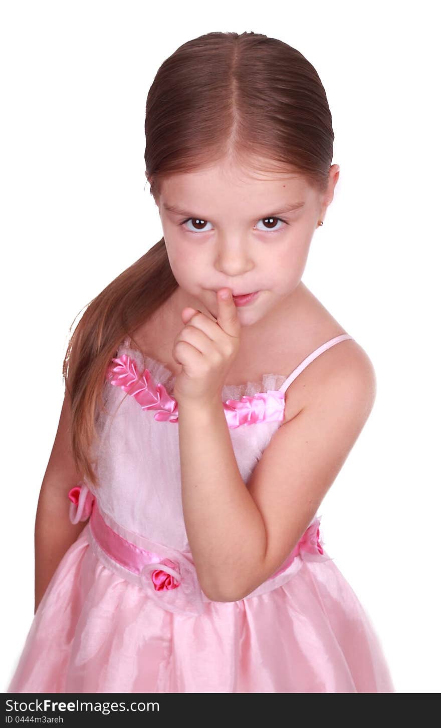 Studio portrait of a beautiful little girl laying a finger on her mouth. Studio portrait of a beautiful little girl laying a finger on her mouth