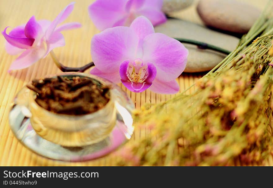 Purple orchid and dried cloves with St. Johns and rocks for spa treatment. Purple orchid and dried cloves with St. Johns and rocks for spa treatment.