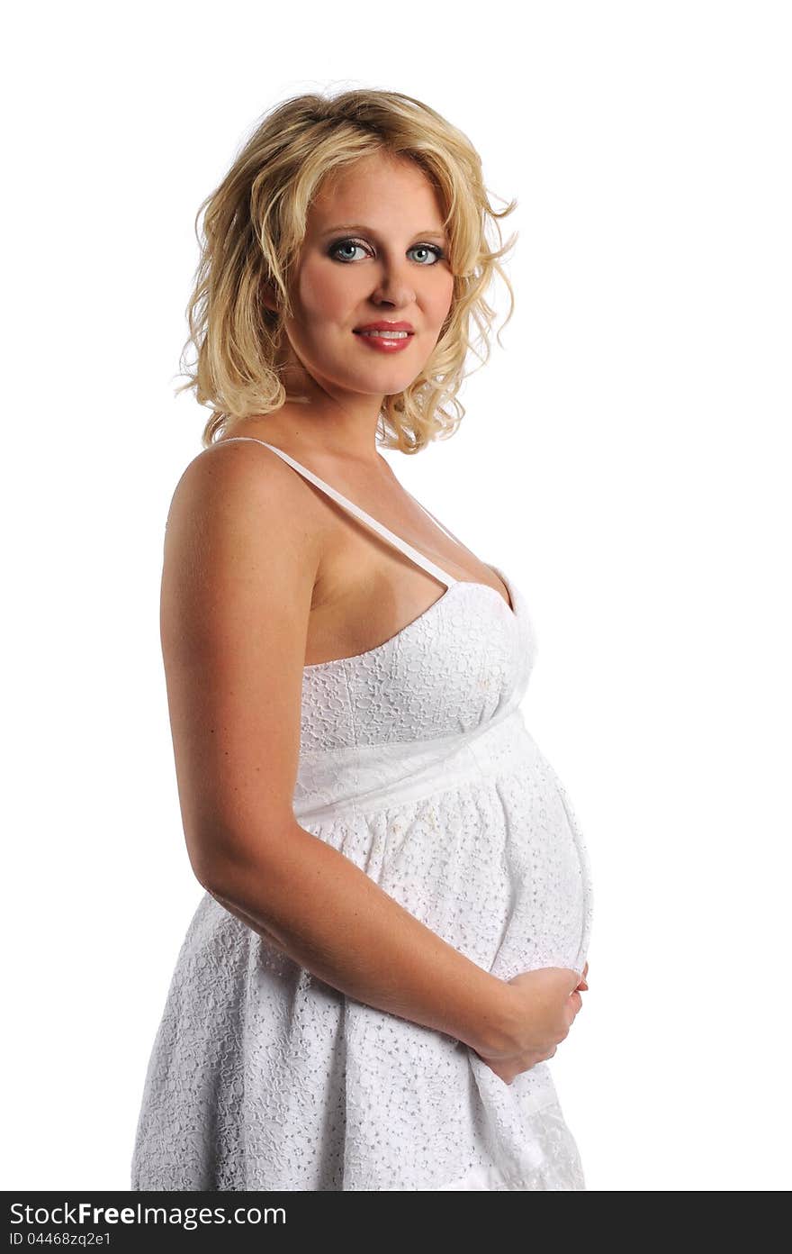 Young pregnant woman smiling and holding her tummy isolated on a white background