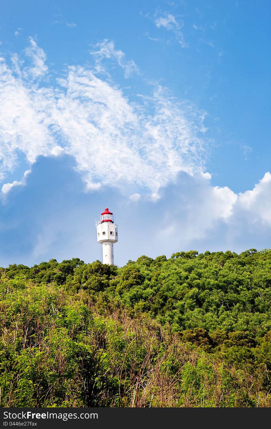 Lighthouse with blue sky white clouds