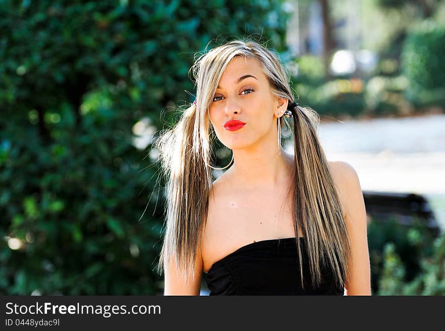 Beautiful and fashion girl with pigtails in the park