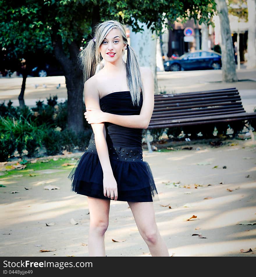 Beautiful and fashion girl with pigtails in the park