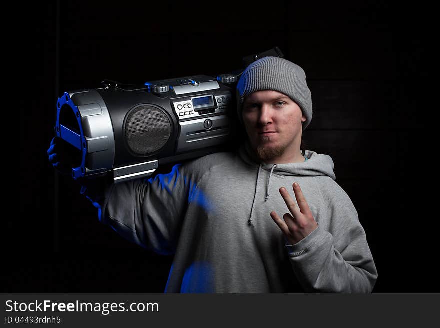 Young man, a dancer, posing with vintage boombox. Young man, a dancer, posing with vintage boombox