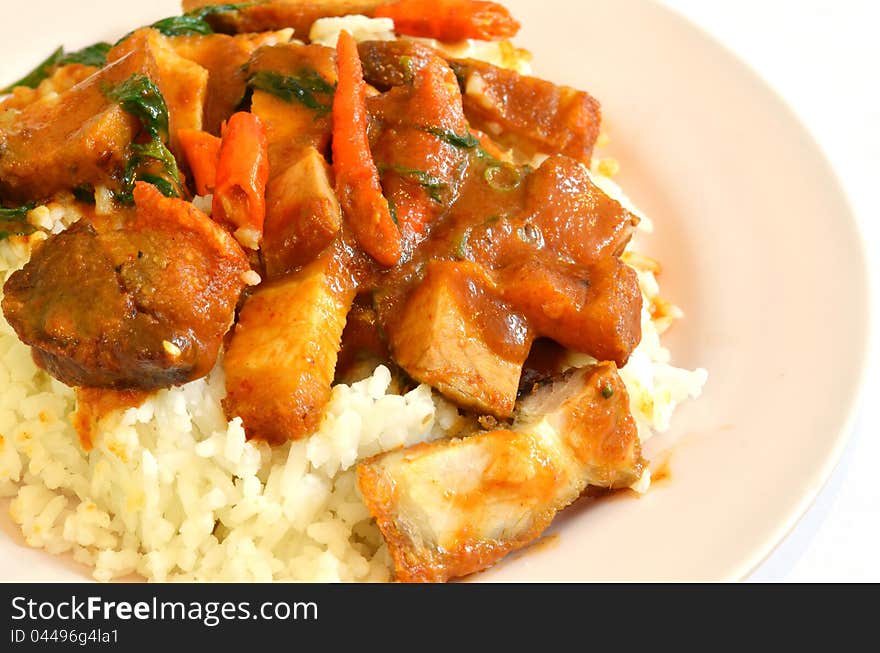 Stir fried crispy pork with red curry paste and rice. Stir fried crispy pork with red curry paste and rice