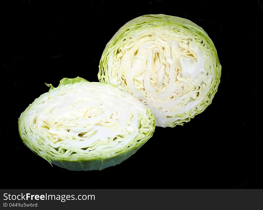 Ripe fresh green cabbage isolated over black background