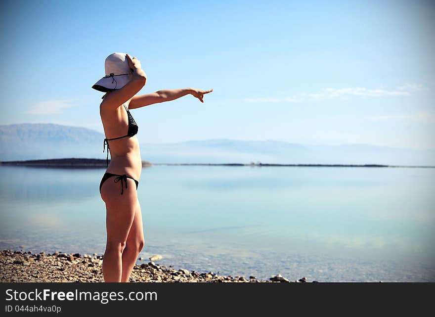 Girl sunbathing on the beach with warm summer day. Girl sunbathing on the beach with warm summer day