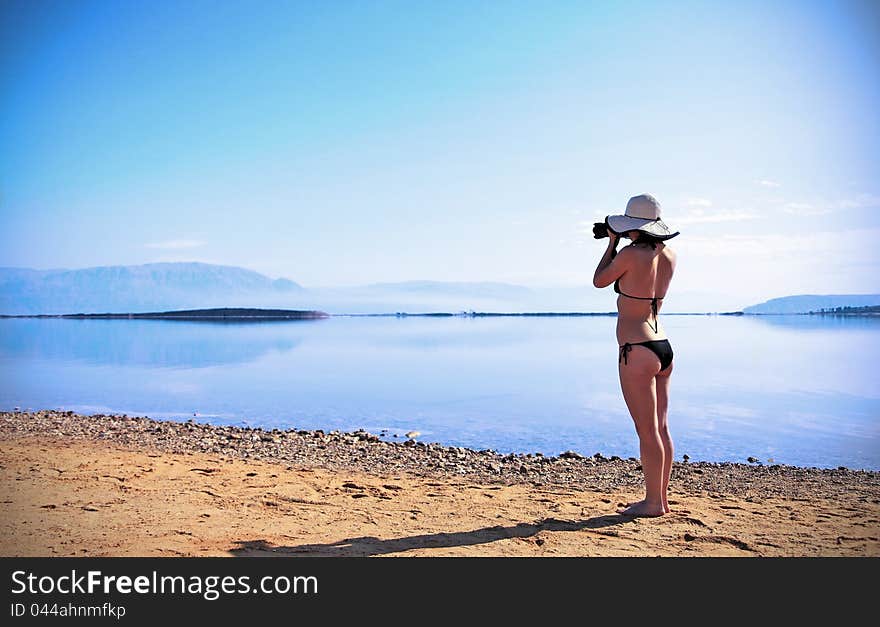 Girl sunbathing on the beach with warm summer day. Girl sunbathing on the beach with warm summer day