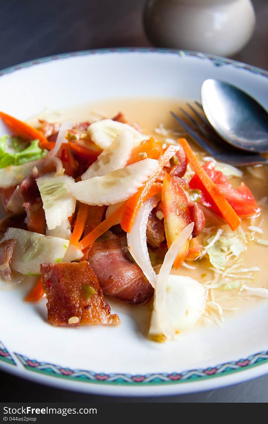 Thai style bacon salad on white plate. Thai style bacon salad on white plate