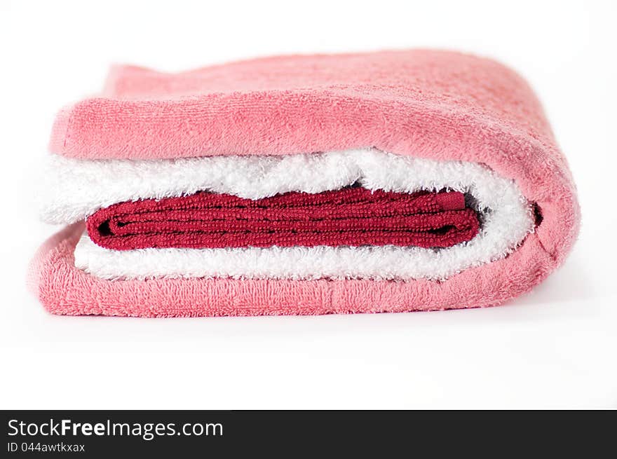 White, red and pink Terry towels on white background