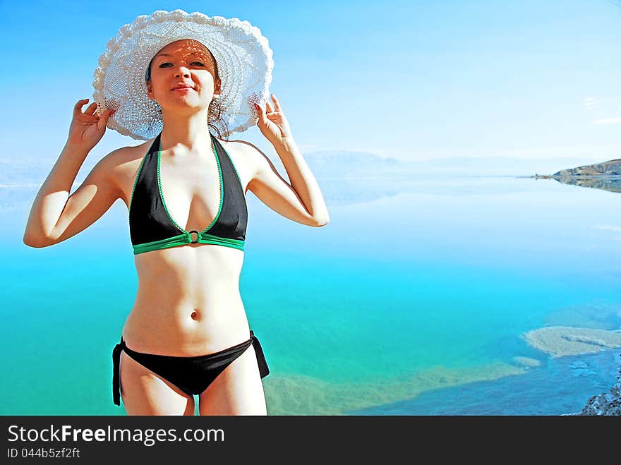 Girl sunbathing on the beach with warm summer day. Girl sunbathing on the beach with warm summer day