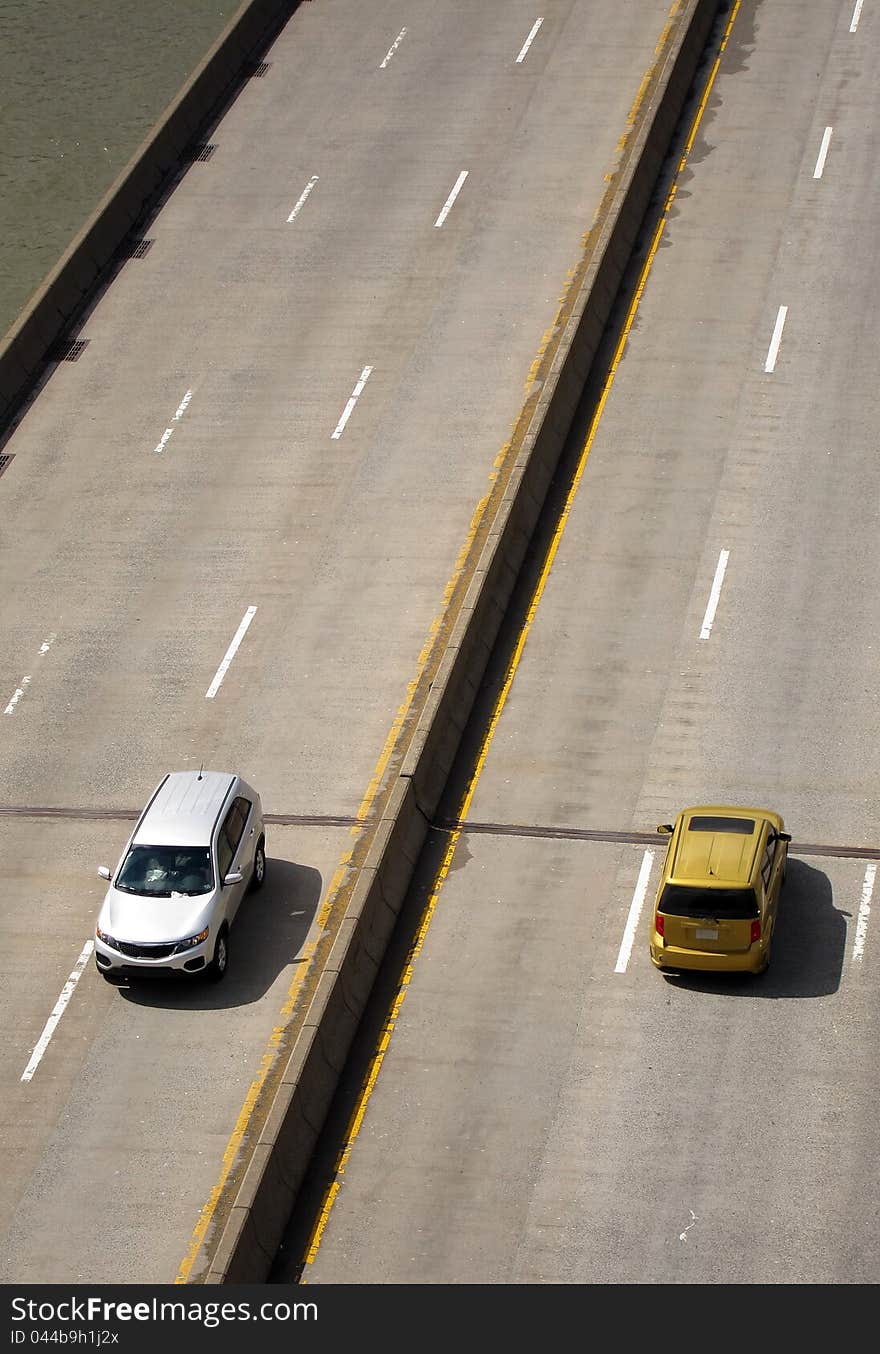 Only two cars on an empty freeway, photo taken in New York. vertical composition. Only two cars on an empty freeway, photo taken in New York. vertical composition