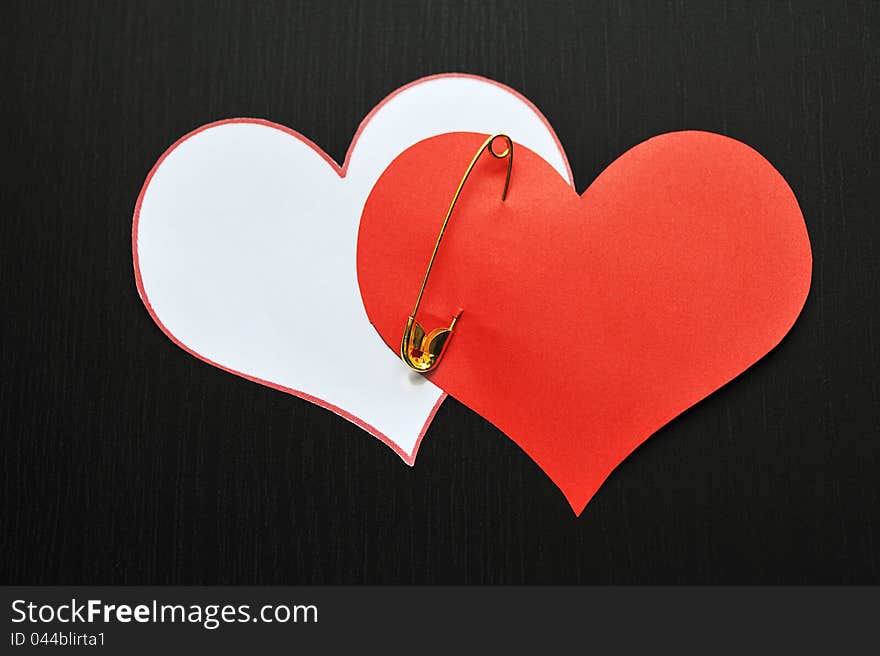 Two pin hearts on dark background. Two pin hearts on dark background