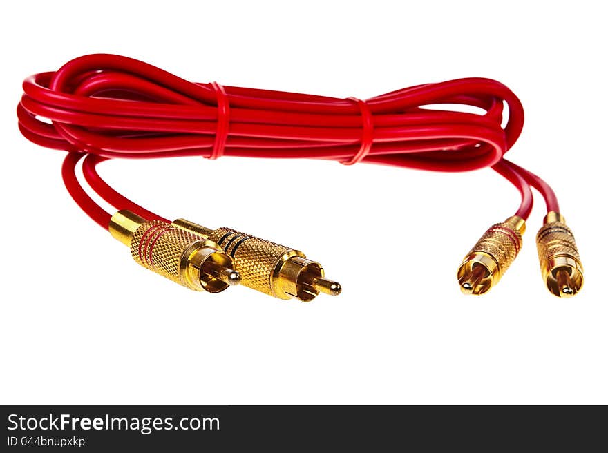 Red cinch audio cable with golden plugs isolated over white background. Red cinch audio cable with golden plugs isolated over white background.