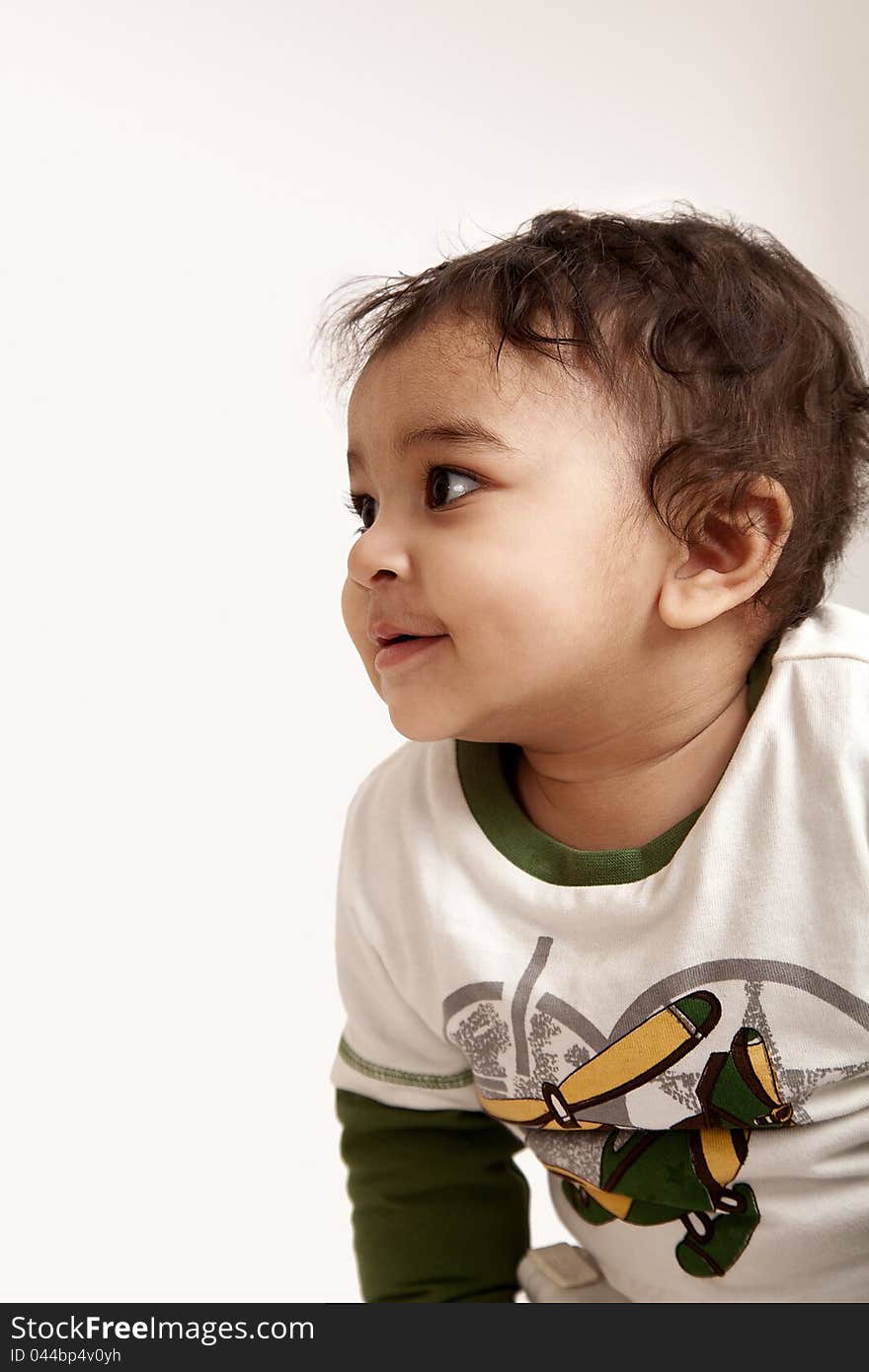 Adorable Indian baby laughing a over white background