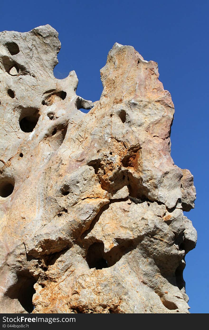 Textured Rock Detail Against A Blue Sky. Textured Rock Detail Against A Blue Sky