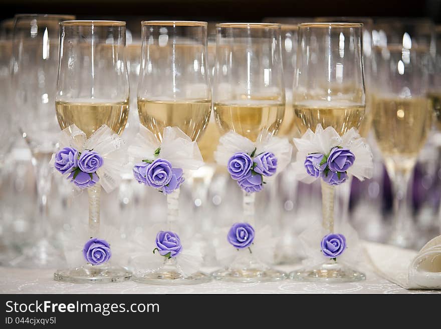 Champagne glasses decorated with artificial flowes