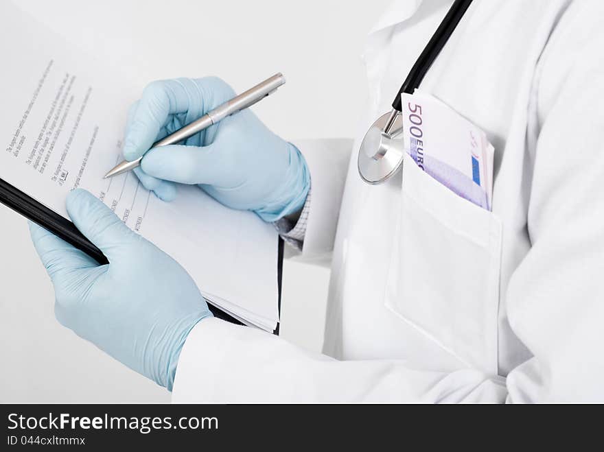 Doctor with stethoscope making notes on clipboard. Doctor with stethoscope making notes on clipboard