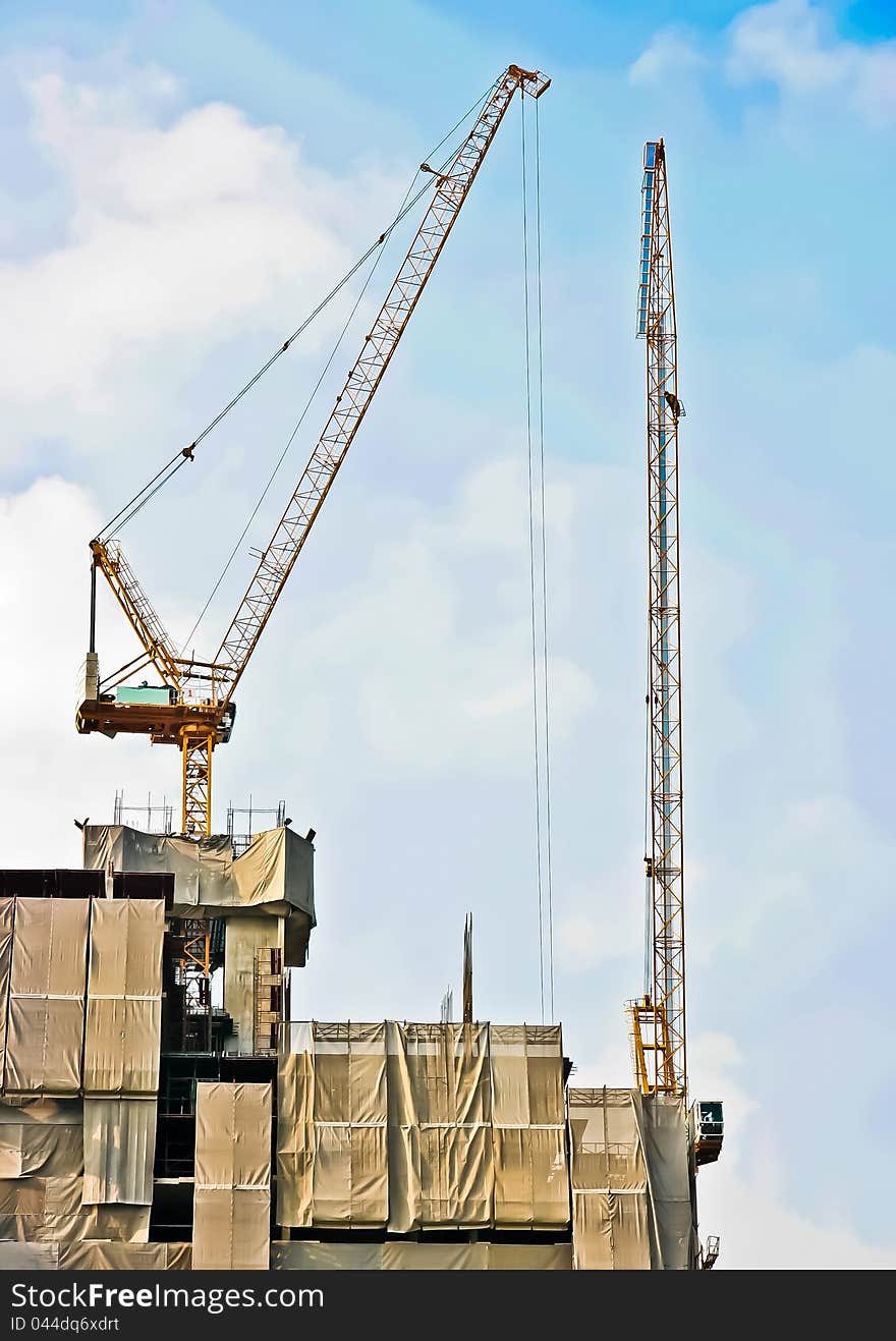 Cranes on the building work in the morning. Cranes on the building work in the morning