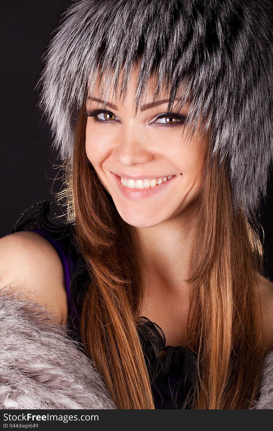 Portrait of a beautiful smiling woman in furs