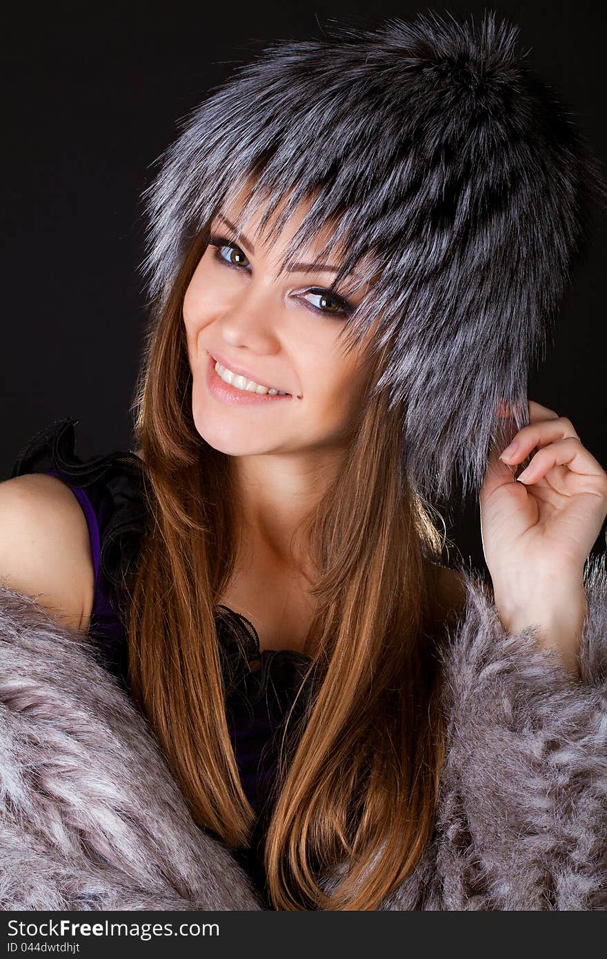 Portrait of a beautiful smiling woman in furs