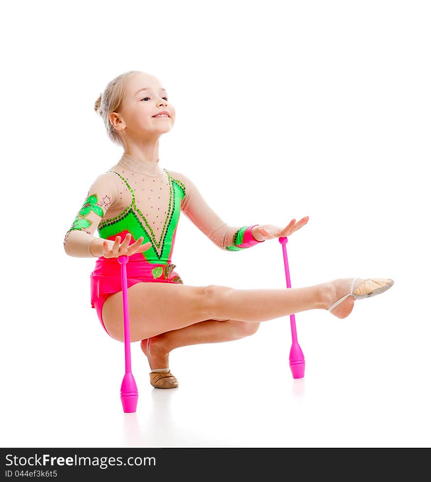 Pretty girl gymnast doing exercises over white background