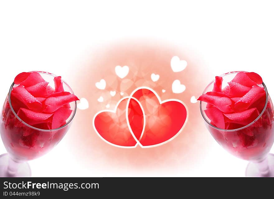 Wine glass with rose petals decorated with dew drops and hearts in the background. Wine glass with rose petals decorated with dew drops and hearts in the background.