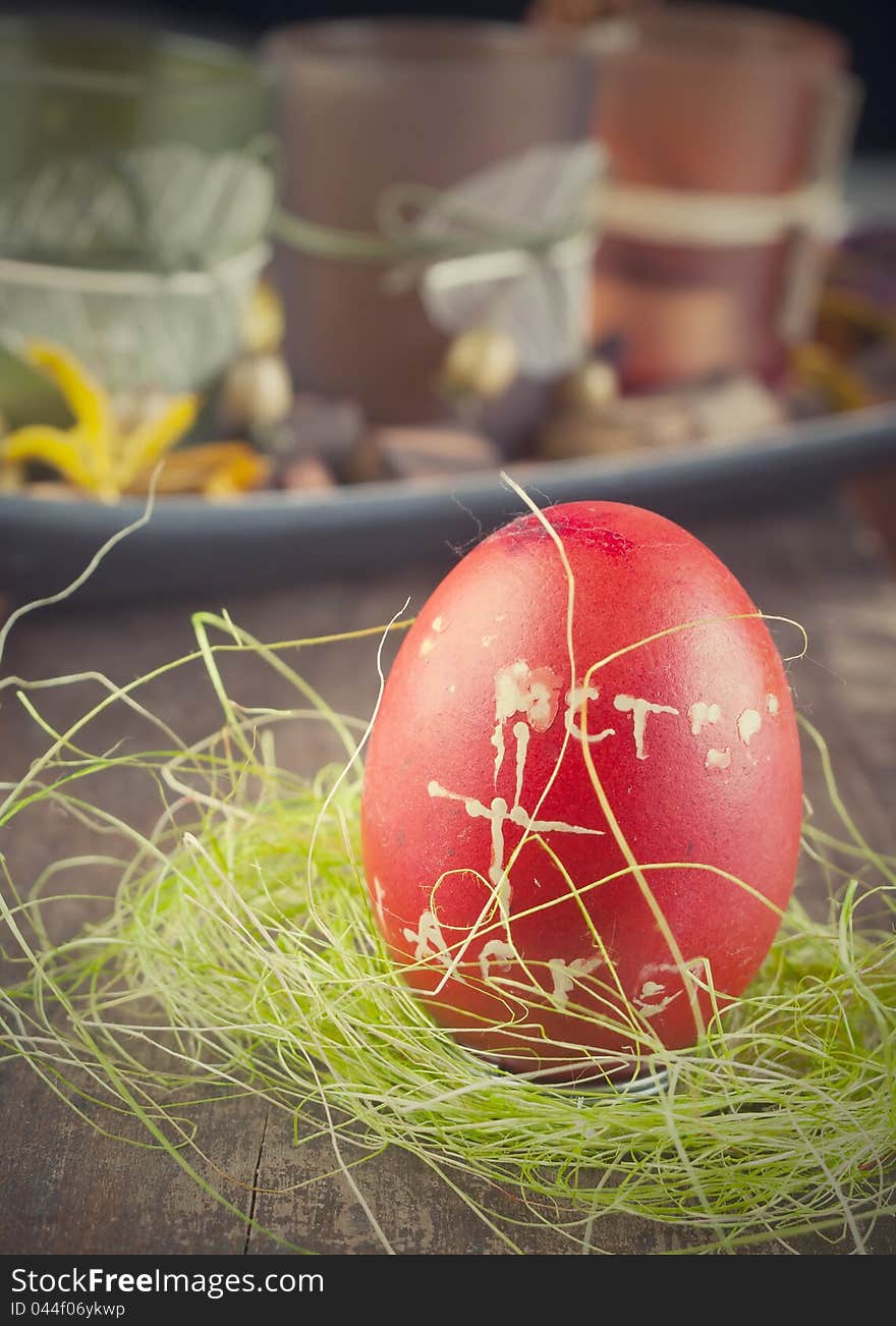 Red easter egg on wooden plank