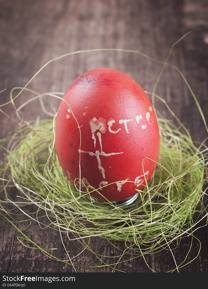 Red easter egg on wooden plank