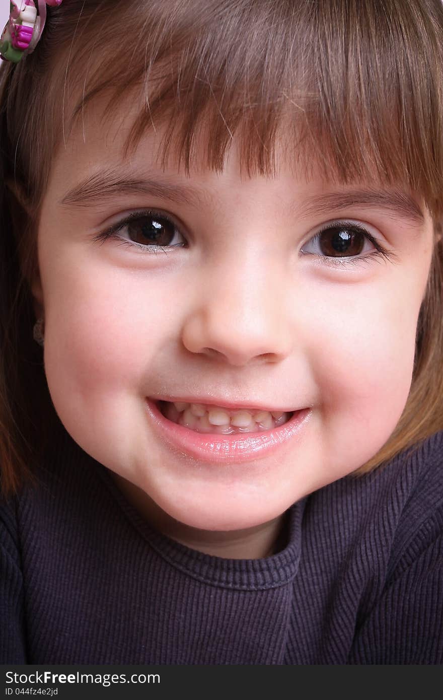 Portrait of a beautiful little girl in a purple mother,children